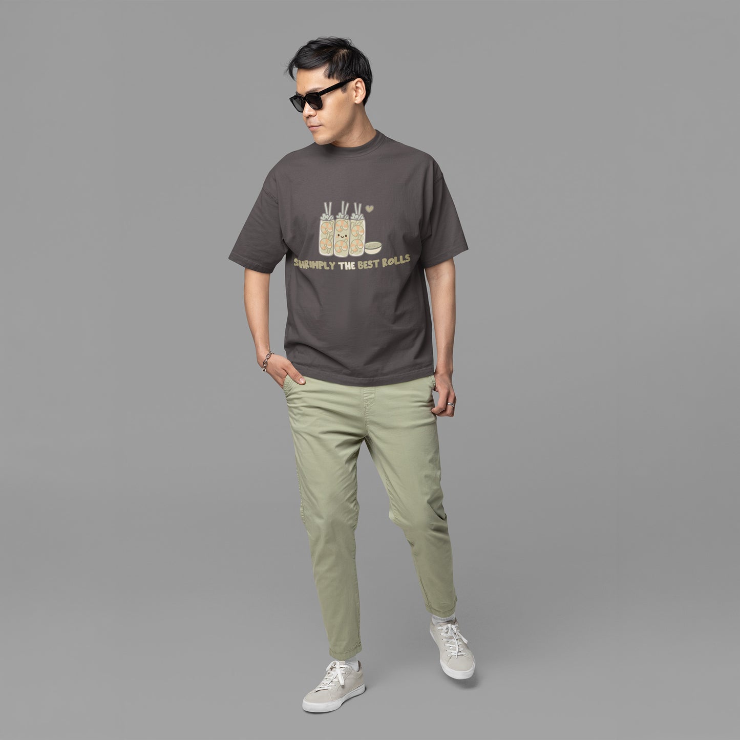 Male wearing a trendy unisex graphite gray oversized graphic tee with cute shrimp spring roll artwork, perfect for teen and young adult casual fashion.
