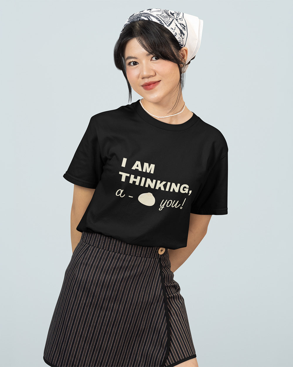 Female model wearing a black kawaii bao bun graphic t-shirt for teen and young adult streetwear size guide.