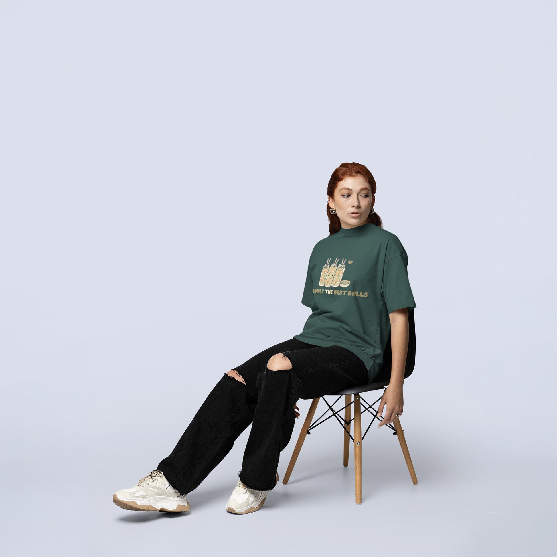 Female wearing a trendy oversized shrimp spring roll graphic tee in blue spruce, styled with black ripped jeans and sneakers for casual kawaii fashion.