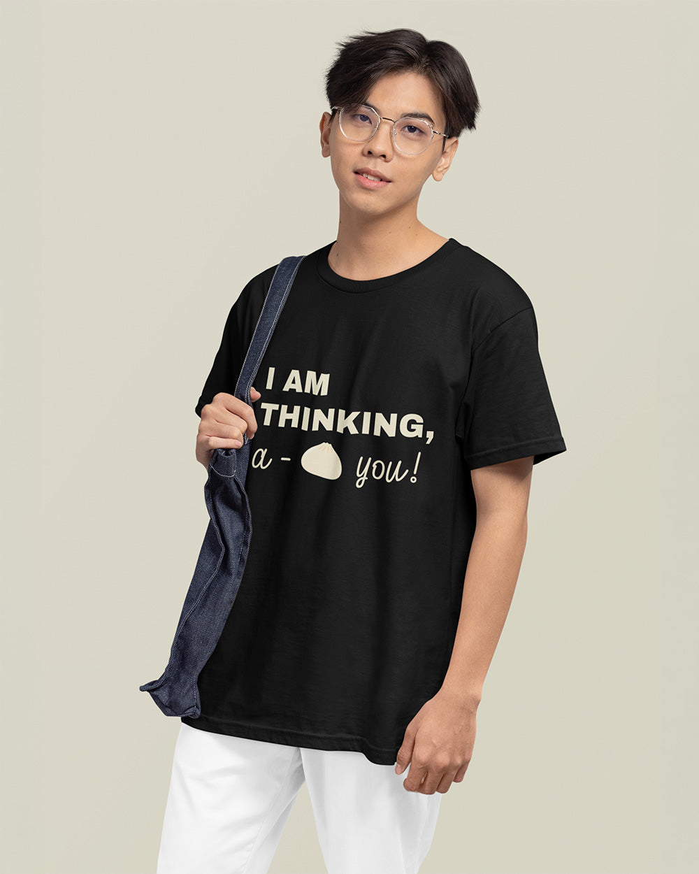 Male model showing relaxed fit black kawaii bao bun graphic t-shirt for trendy teen and young adult fashion.