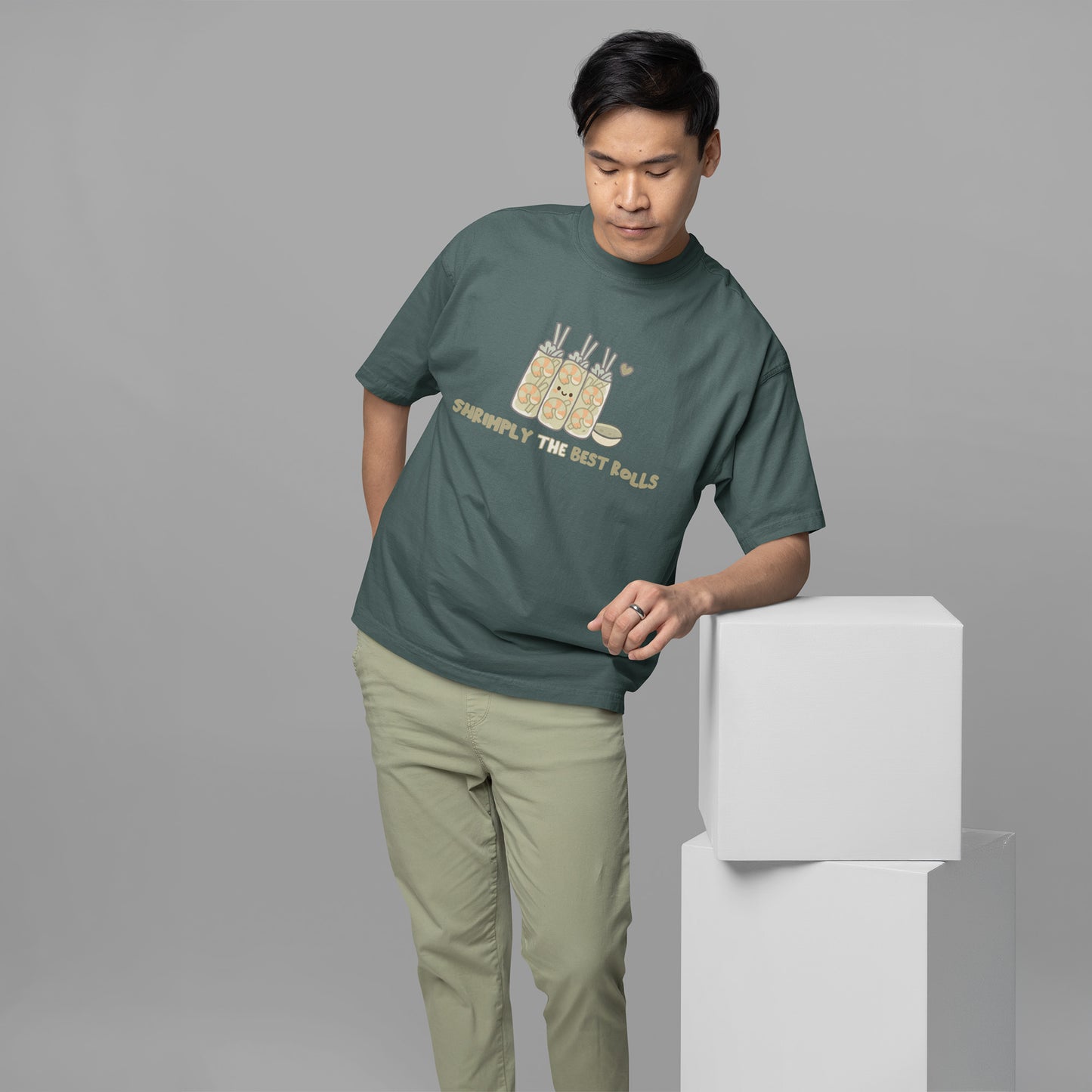 Male wearing a casual unisex shrimp spring roll graphic t-shirt in blue spruce with comfy oversized fit, perfect for cute foodie streetwear lovers.