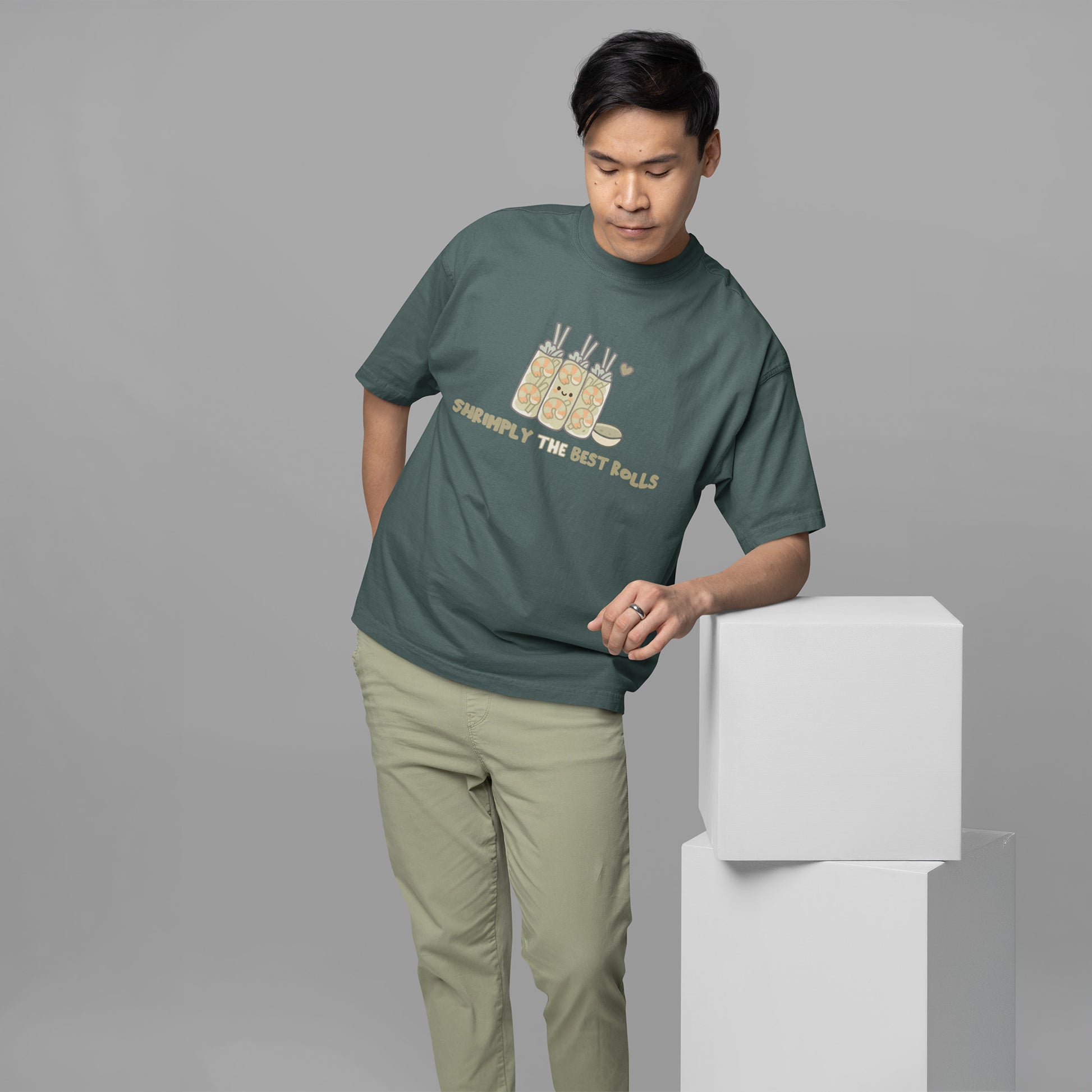 Male wearing a casual unisex shrimp spring roll graphic t-shirt in blue spruce with comfy oversized fit, perfect for cute foodie streetwear lovers.