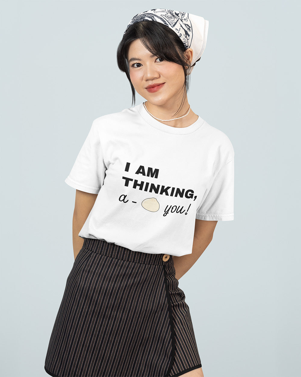 Female model wearing white kawaii bao bun graphic t-shirt for teen and young adult casual streetwear size guide.