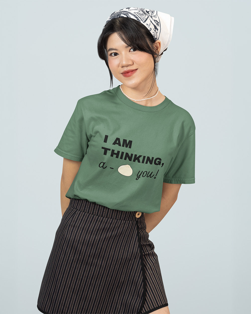 Female model wearing light green kawaii bao bun graphic t-shirt for teen and young adult casual streetwear size guide.