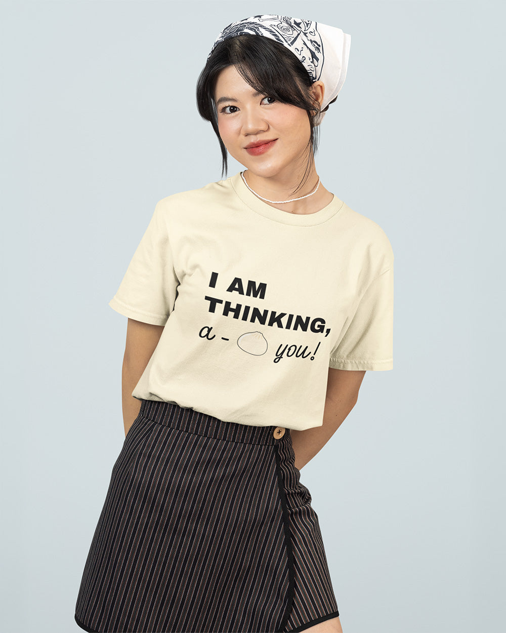 Female model wearing ivory kawaii bao bun graphic t-shirt for teen and young adult casual streetwear size guide.