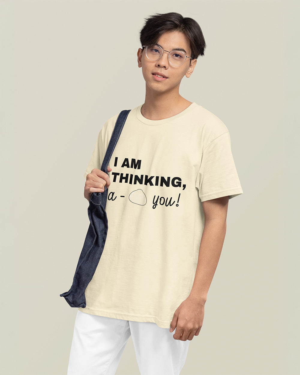 Male model showing relaxed fit ivory kawaii food graphic t-shirt for modern teen and young adult streetwear.