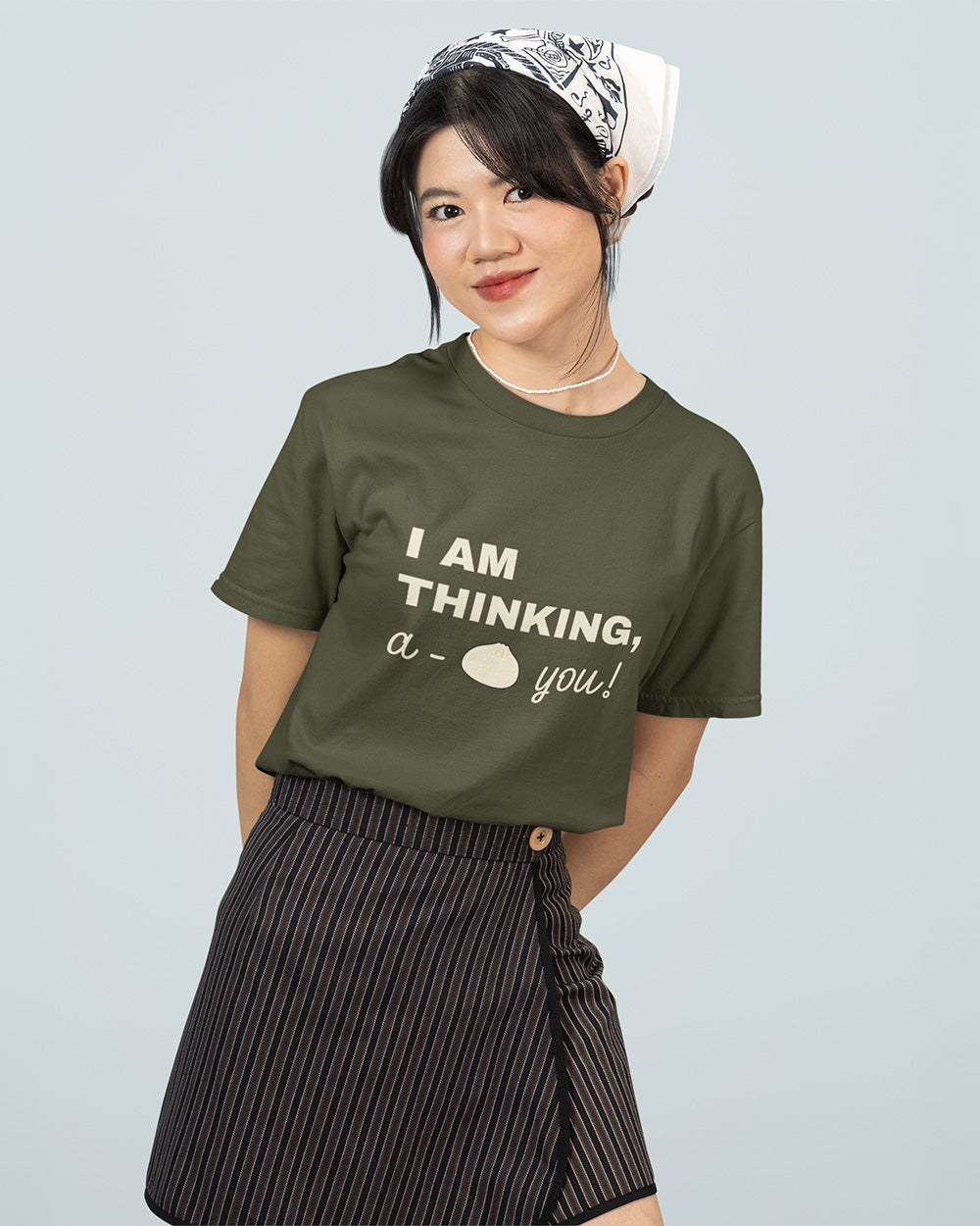 Female model wearing sage green kawaii bao bun graphic t-shirt for teen and young adult casual streetwear size guide.