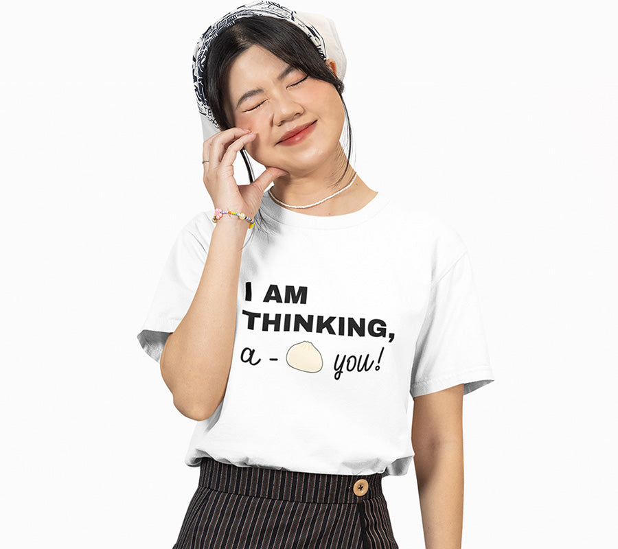 Eyes closing and smiling girl in white graphic t-shirt with Chinese bao bun and says I Am Thinking A-Bao You